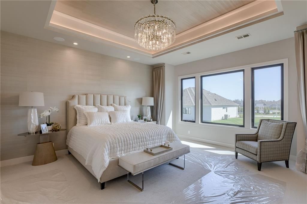 Main-floor primary bedroom, tray ceiling and carpet at 13610 Granada Drive, Leawood, KS 66224