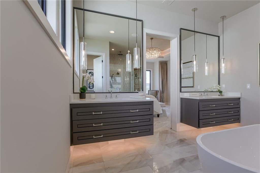 Double vanity, gray vanity and renovated bathrooms at 13610 Granada Drive, Leawood, KS 66224