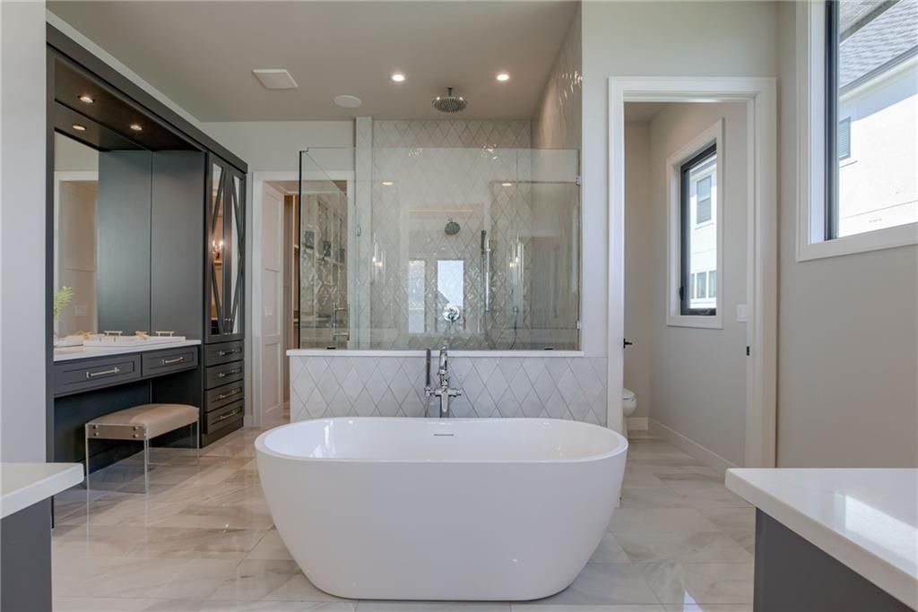 Walk-in shower, freestanding tub and private toilet room at 13610 Granada Drive, Leawood, KS 66224