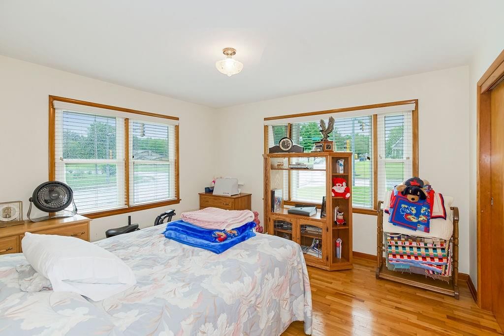 Hardwood floors, white walls and main-floor primary bedroom at 911 Limit Street, Leavenworth, KS 66048