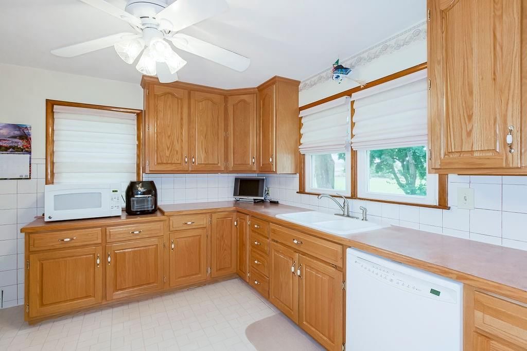 Kitchen backsplash, wood kitchen cabinets and raised-panel cabinets at 911 Limit Street, Leavenworth, KS 66048
