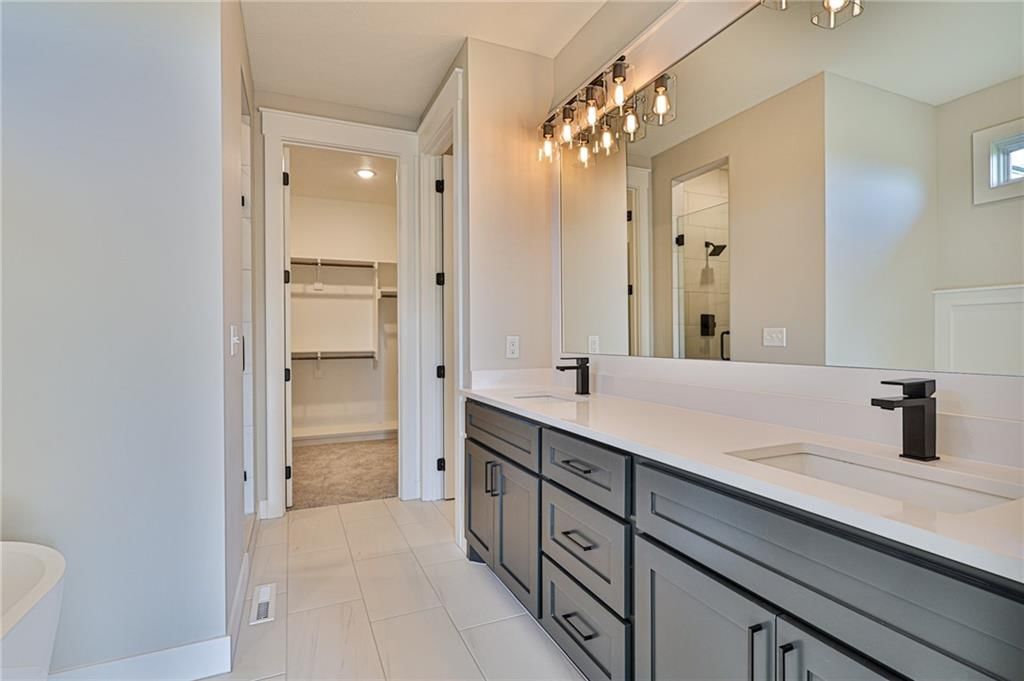 Walk-in shower, tiled shower and double vanity at 14014 Crawford Creek Circle, Lake Lotawana, MO 64034