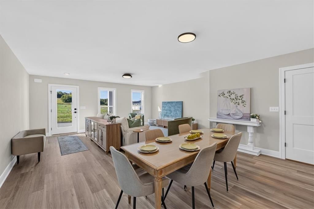 Kitchen island, statement lighting and white countertops at 23706 E 11th Street S, Blue Springs, MO 64056