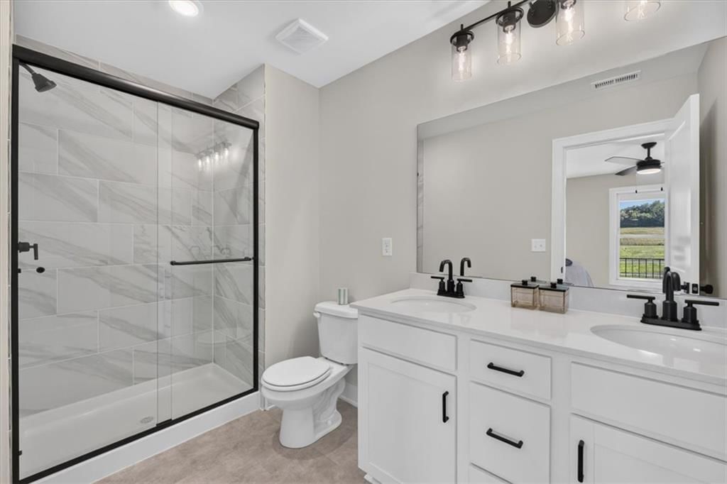 Walk-in shower, tiled shower and double vanity at 23706 E 11th Street S, Blue Springs, MO 64056