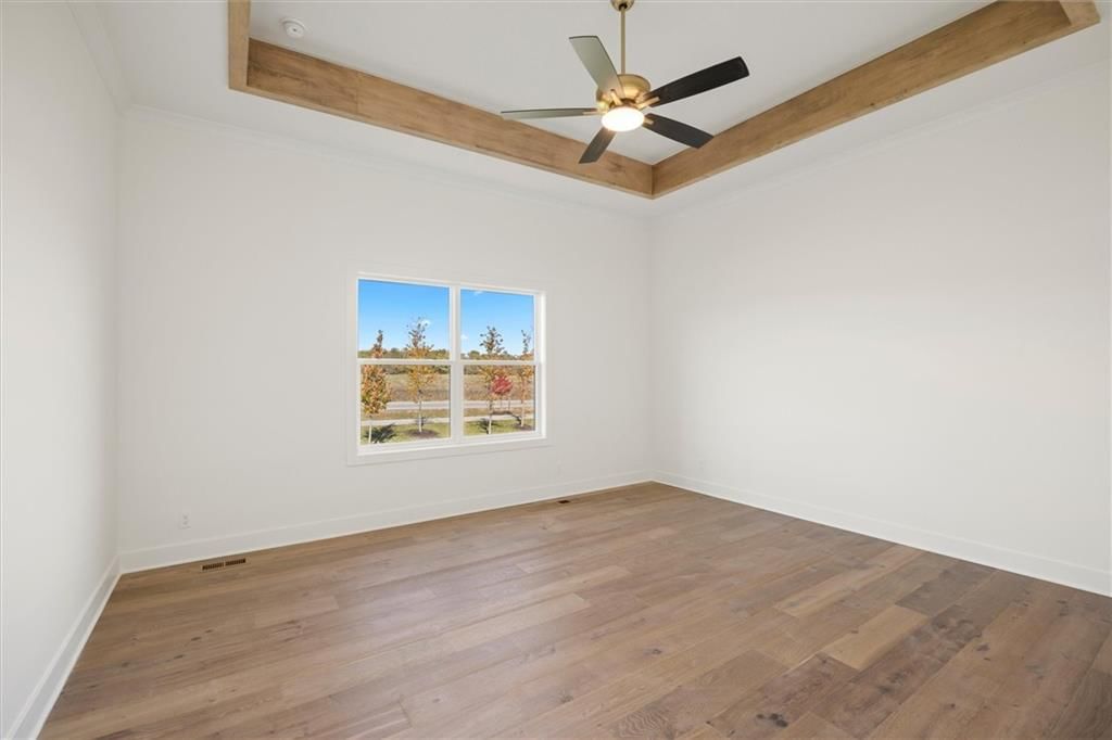 Main-floor primary bedroom and tray ceiling at 17028 Rosehill Street, Overland Park, KS 66221