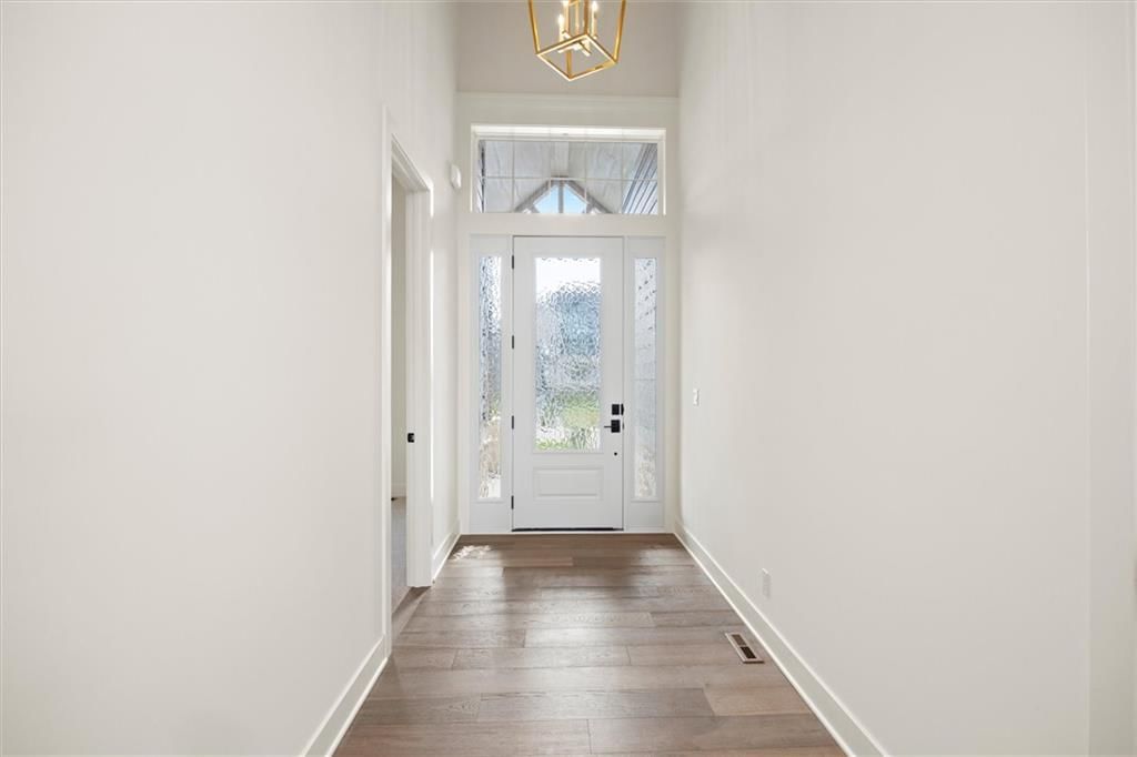 Hardwood floors, white trim and white walls at 17028 Rosehill Street, Overland Park, KS 66221