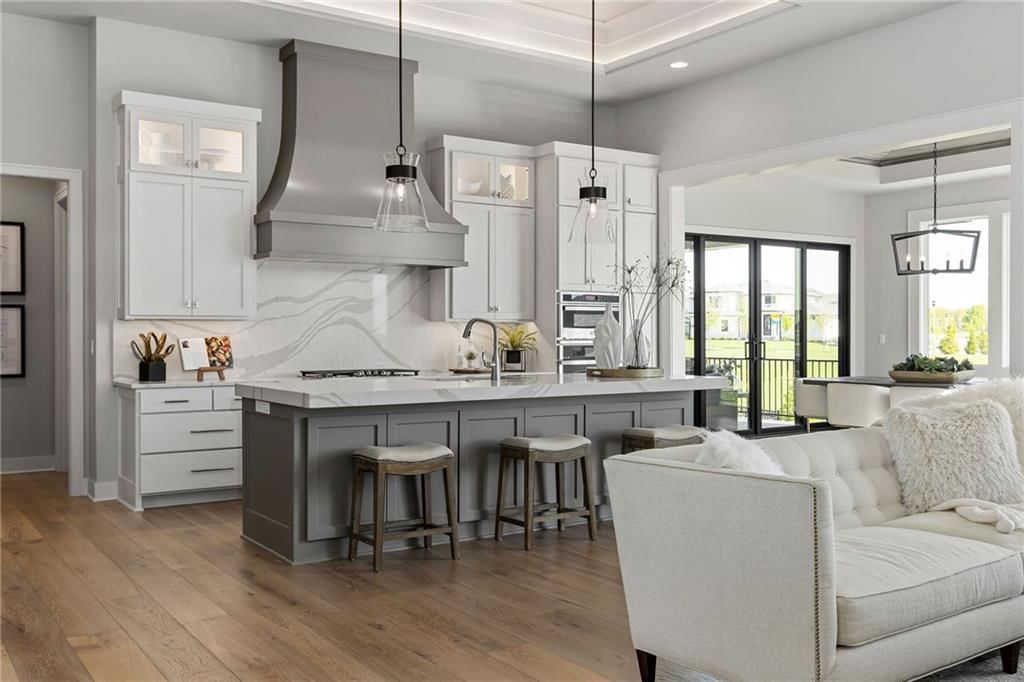 Kitchen island, white kitchen and quartz counters at 13701 Guilford Road, Leawood, KS 66224