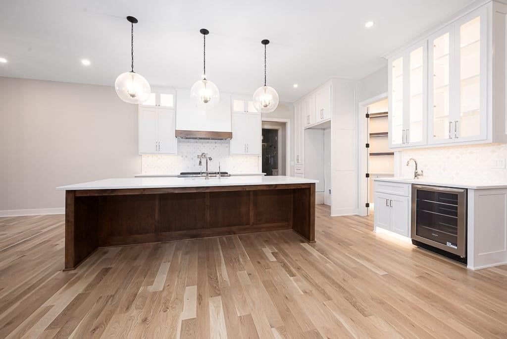 White kitchen, quartz counters and shaker cabinets at 18005 235th Street, Tonganoxie, KS 66086