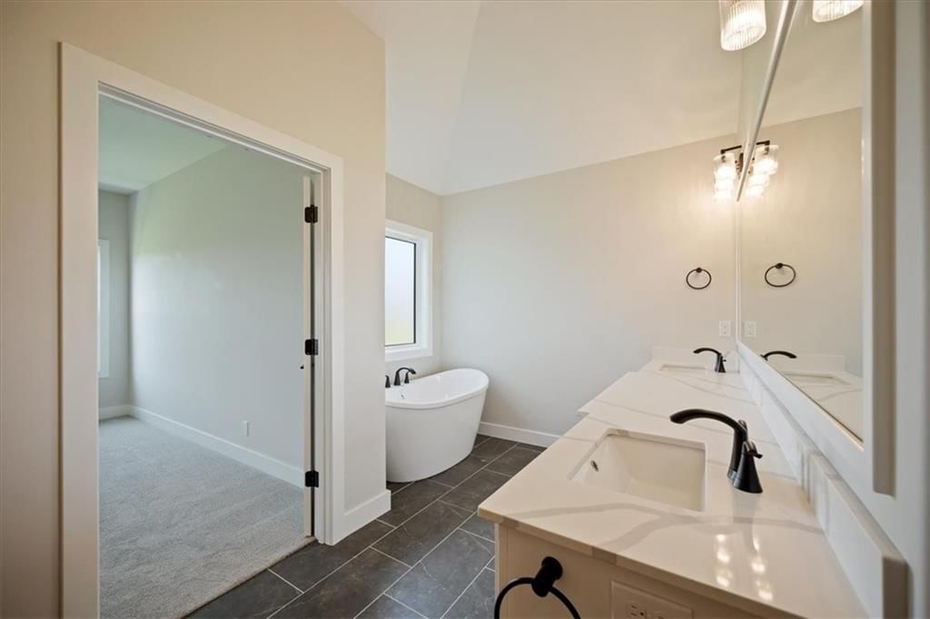 Frameless glass shower and tiled shower at 2622 SW Barley Field Drive, Lee's Summit, MO 64082