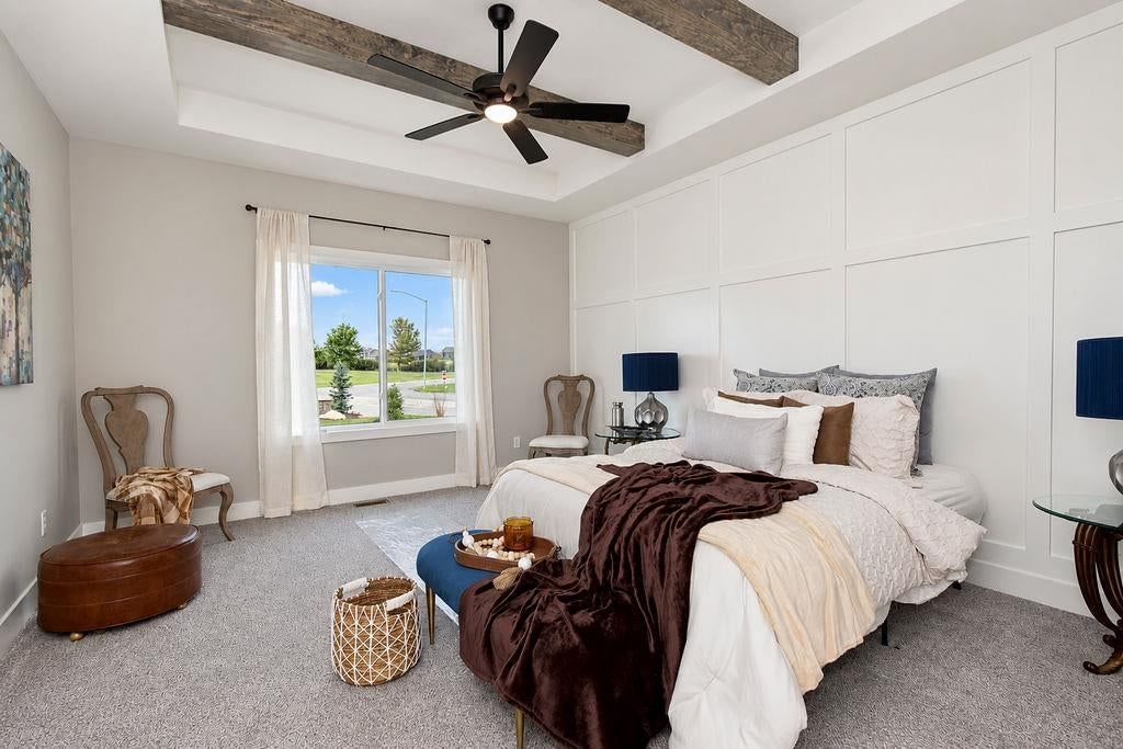 Main-floor primary bedroom and wainscoting or board and batten at 27602 E 128th Court, Lake Lotawana, MO 64086
