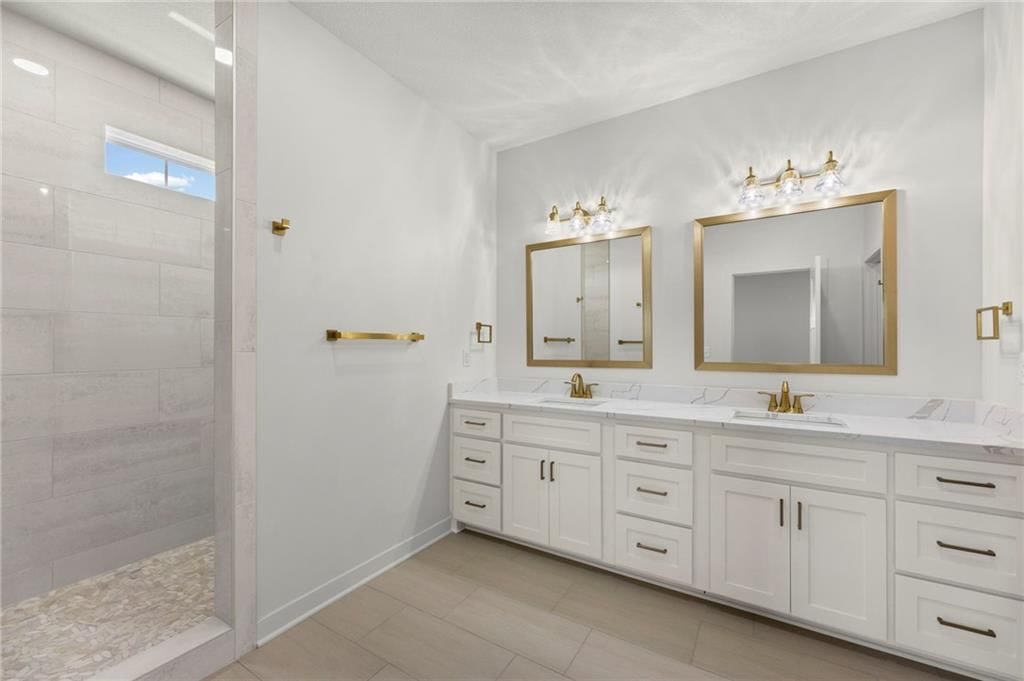Walk-in shower and tiled shower at 4467 Tee Box Drive, Basehor, KS 66007
