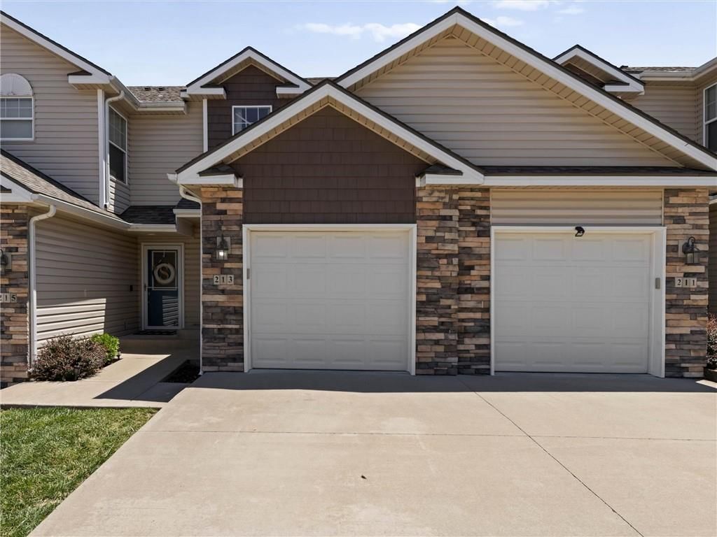 Attached garage, gray roof and asphalt shingle roof at 213 Pointe Lane, Raymore, MO 64083