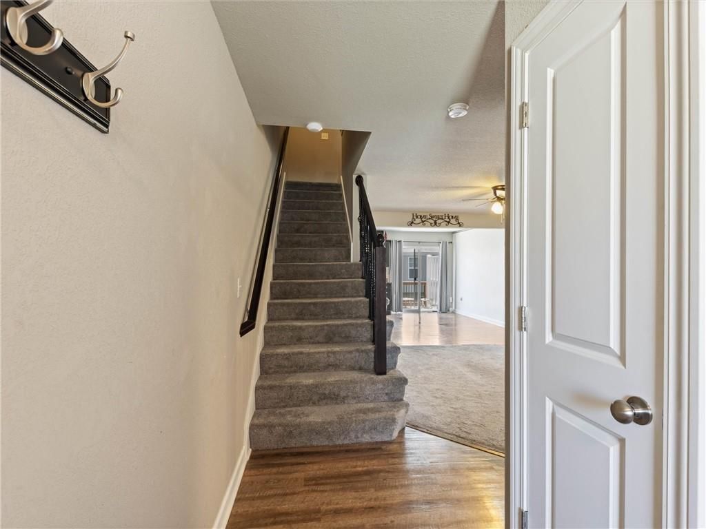 Staircase and iron stair railing at 213 Pointe Lane, Raymore, MO 64083
