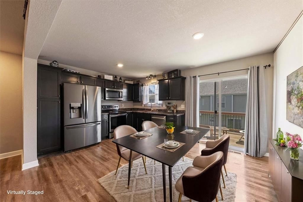 Black hardware, updated kitchen and granite counters at 213 Pointe Lane, Raymore, MO 64083