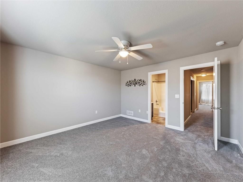 Tiled shower, black vanity and renovated bathrooms at 213 Pointe Lane, Raymore, MO 64083
