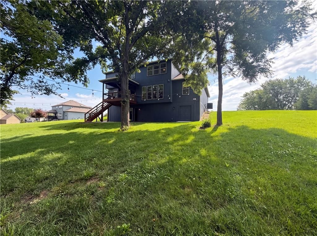 Mature trees, covered patio and deck at 7540 N Amity Avenue, Kansas City, MO 64152
