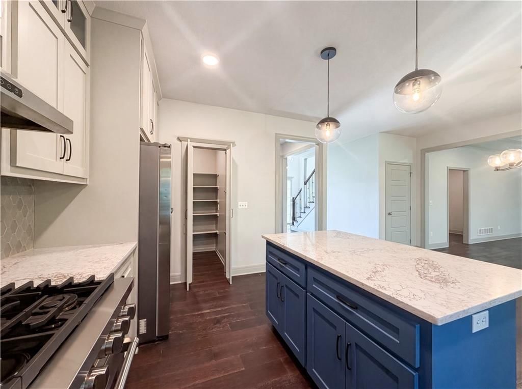 Walk-in pantry, staircase and wood stair railing at 7540 N Amity Avenue, Kansas City, MO 64152