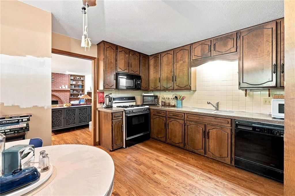 Kitchen open to the living area and gas range at 2509 10th Avenue, Leavenworth, KS 66048