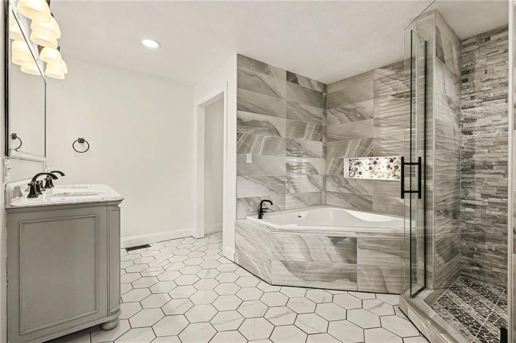 Tile floors, double vanity and black hardware at 3322 N 67th Street, Kansas City, KS 66104