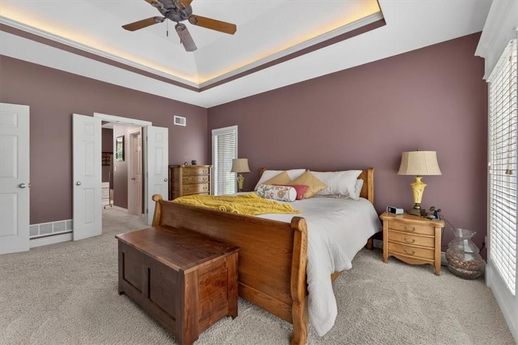Main-floor primary bedroom and tray ceiling at 9406 Pleasant Avenue, Kansas City, MO 64138
