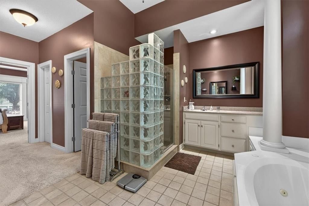 Walk-in shower and tiled shower at 9406 Pleasant Avenue, Kansas City, MO 64138