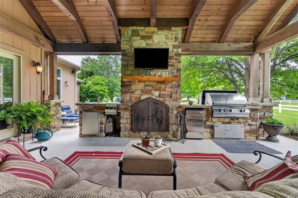Big backyard, outdoor kitchen and outdoor fireplace at 9406 Pleasant Avenue, Kansas City, MO 64138