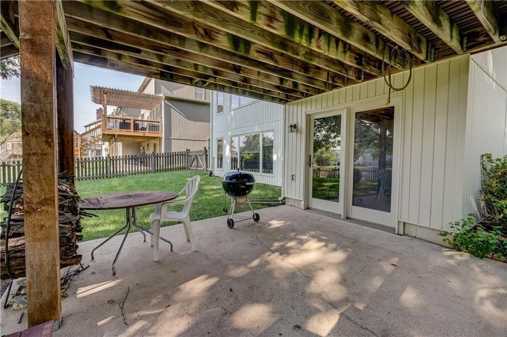 Covered patio and concrete patio at 512 Canterbury Lane, Lee's Summit, MO 64063
