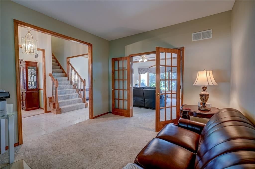 White trim, staircase and wood stair railing at 512 Canterbury Lane, Lee's Summit, MO 64063