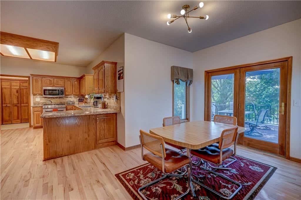 Hardwood floors, kitchen island and granite counters at 512 Canterbury Lane, Lee's Summit, MO 64063