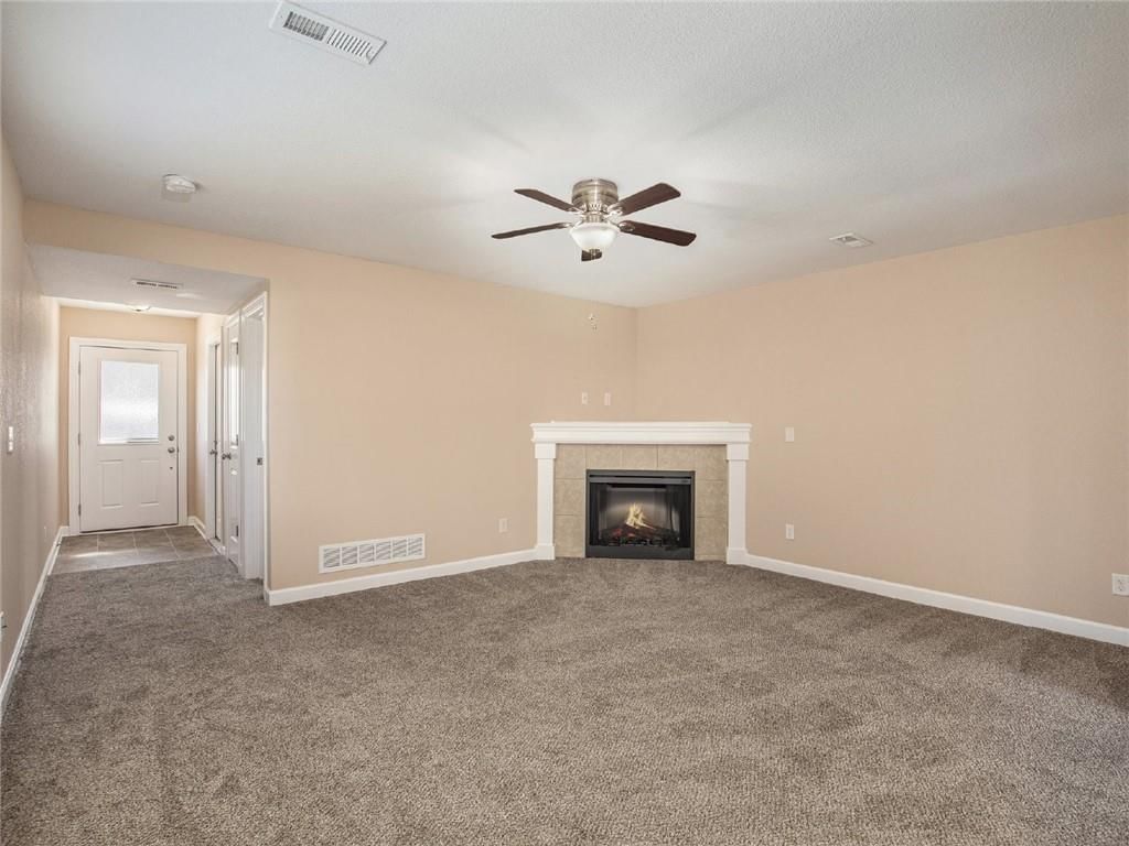 White trim, fireplace and beige walls at 254 Pointe Lane, Raymore, MO 64083