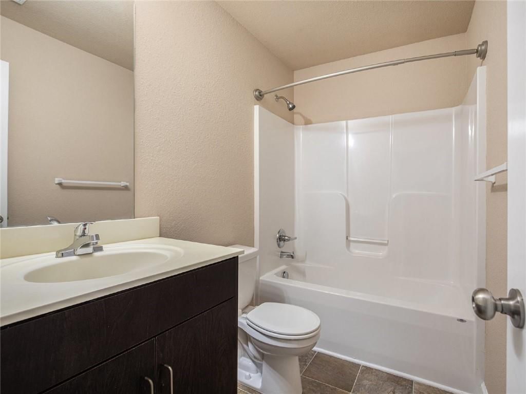 Double vanity and dark vanity color at 254 Pointe Lane, Raymore, MO 64083