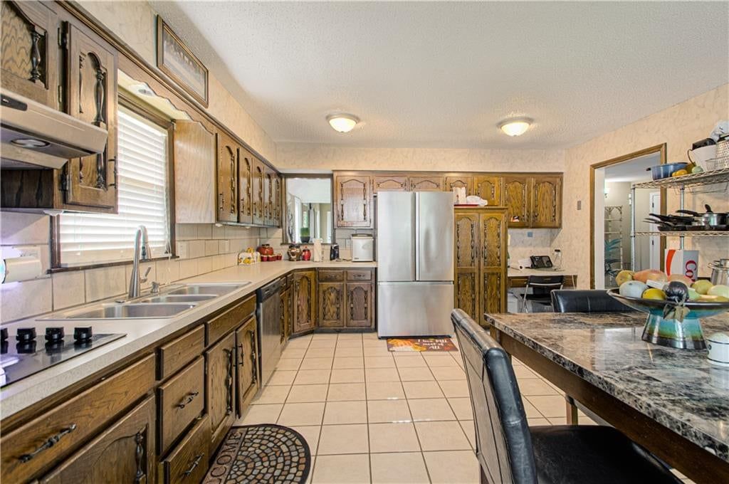 Black hardware, granite counters and stainless steel appliances at 9803 Colony Place, Kansas City, MO 64131