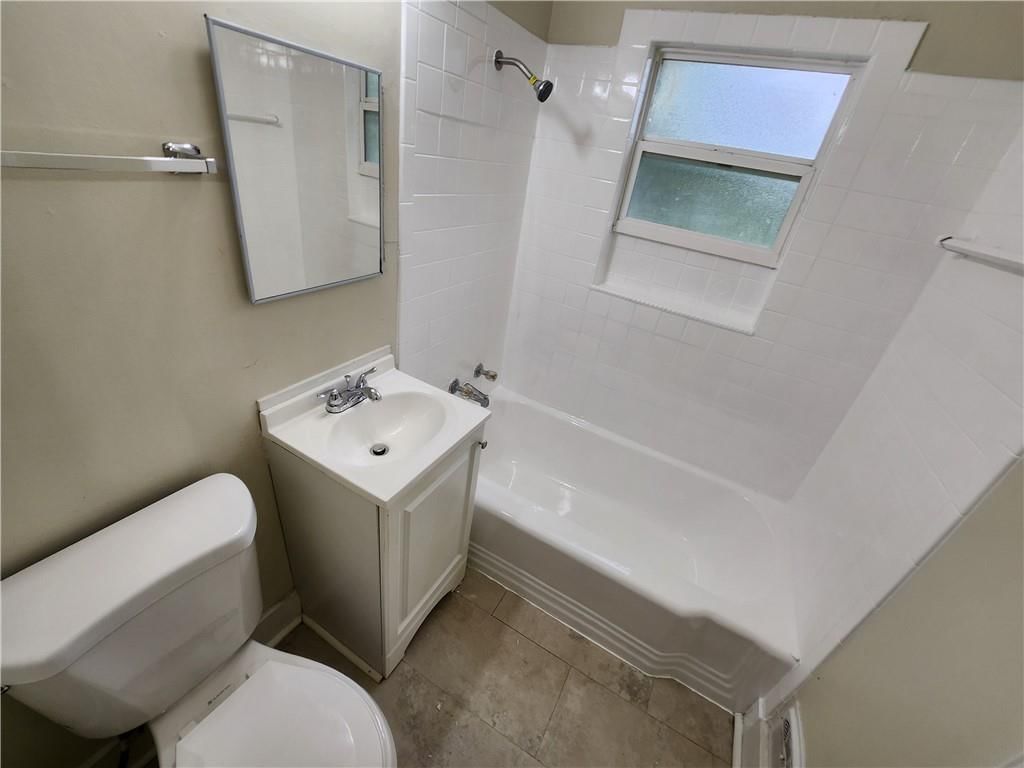 Tiled shower, renovated bathrooms and main-floor primary bedroom at 6601 E 96TH Street, Kansas City, MO 64134
