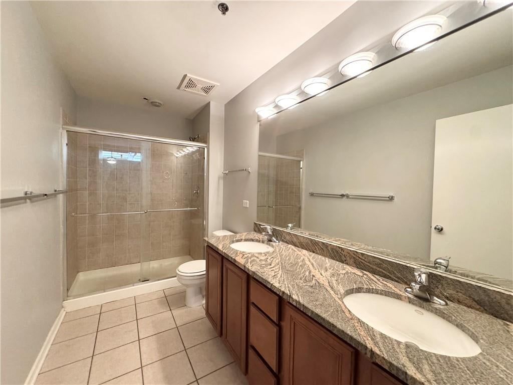 Walk-in shower, tiled shower and double vanity at 2015 Grand #425 Boulevard #425, Kansas City, MO 64108