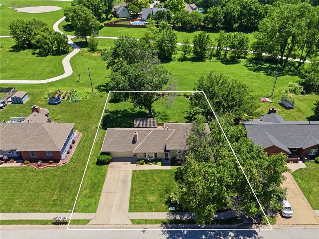 Mature trees, big backyard and flat lot at 503 S Park Drive, Raymore, MO 64083
