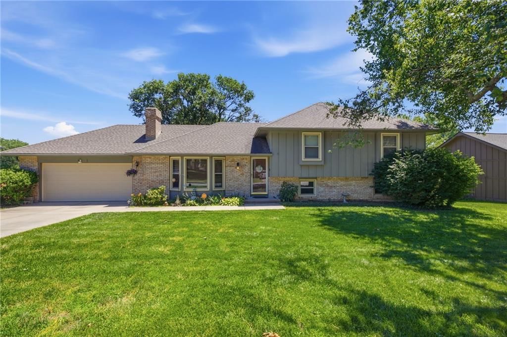 Attached garage, gray roof and asphalt shingle roof at 503 S Park Drive, Raymore, MO 64083
