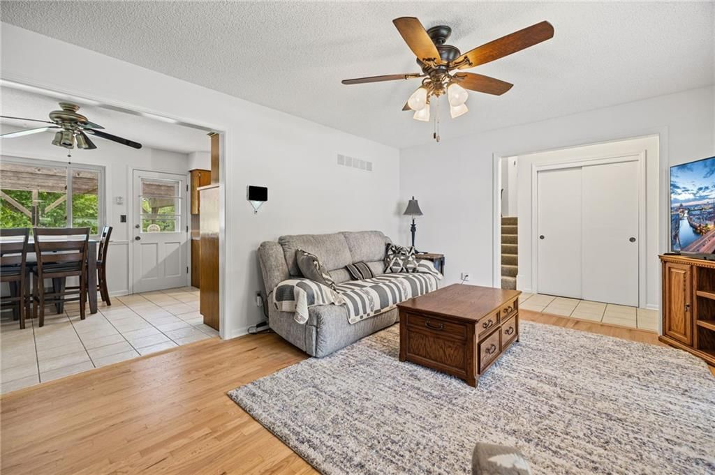 Open floor plan, hardwood floors and white trim at 503 S Park Drive, Raymore, MO 64083