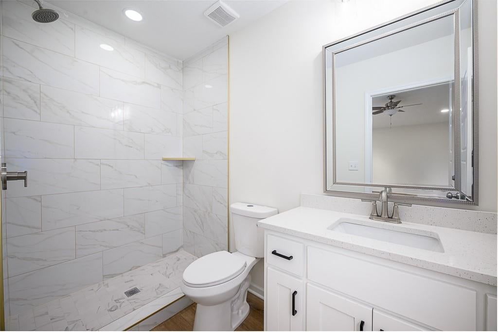 Frameless glass shower, tiled shower and white vanity at 1122 Randolph Street, Leavenworth, KS 66048