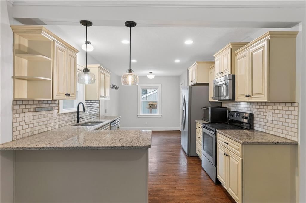 Hardwood floors, granite counters and stainless steel appliances at 7303 Madison Avenue, Kansas City, MO 64114