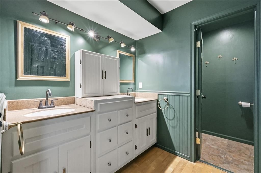 Walk-in shower, double vanity and frameless glass shower at 5519 NW Verlin Drive, Kansas City, MO 64152