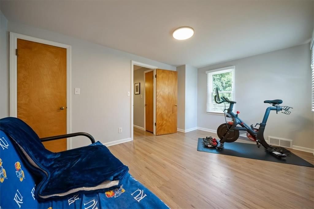 Finished basement, staircase and wood stair railing at 9119 Washington Street, Kansas City, MO 64114