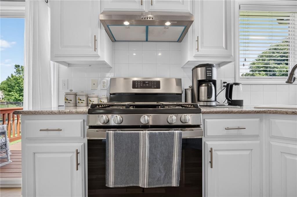 White kitchen, open floor plan and tall ceilings at 16222 W 157th Terrace, Olathe, KS 66062
