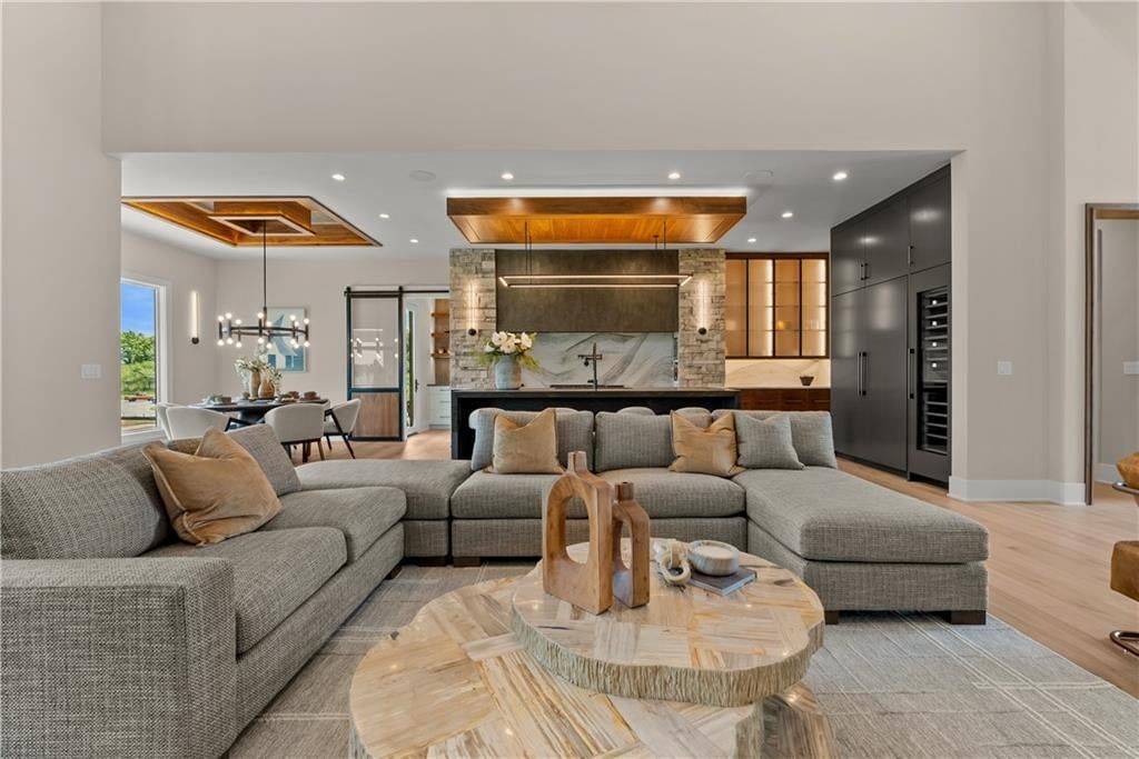 Fireplace and floor-to-ceiling windows at 17375 Galloway Drive, Stilwell, KS 66085