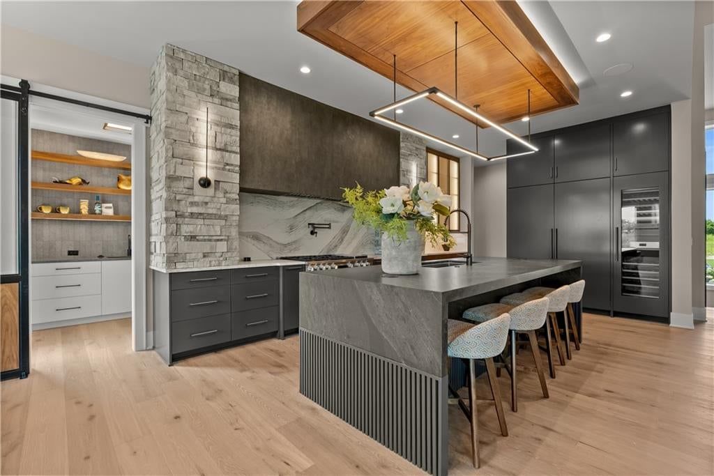Open floor plan, kitchen island and quartz counters at 17375 Galloway Drive, Stilwell, KS 66085