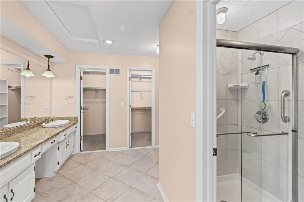 Tile floors, tiled shower and double vanity at 4965 Somerset Drive, Prairie Village, KS 66207