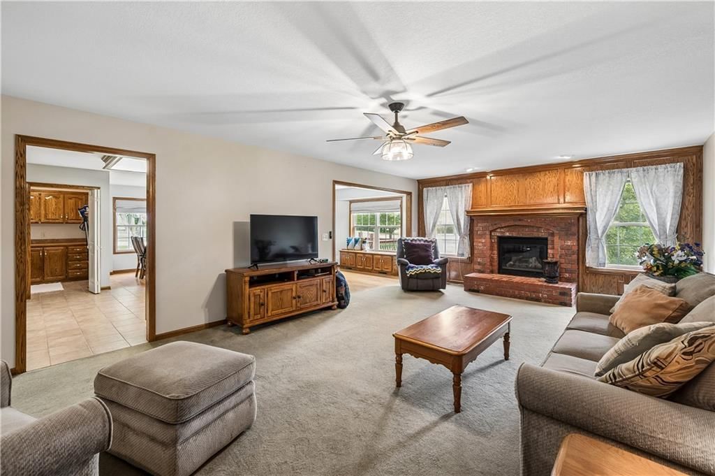 Fireplace, open floor plan and wall of windows at 1707 Lynn Road, Excelsior Springs, MO 64024
