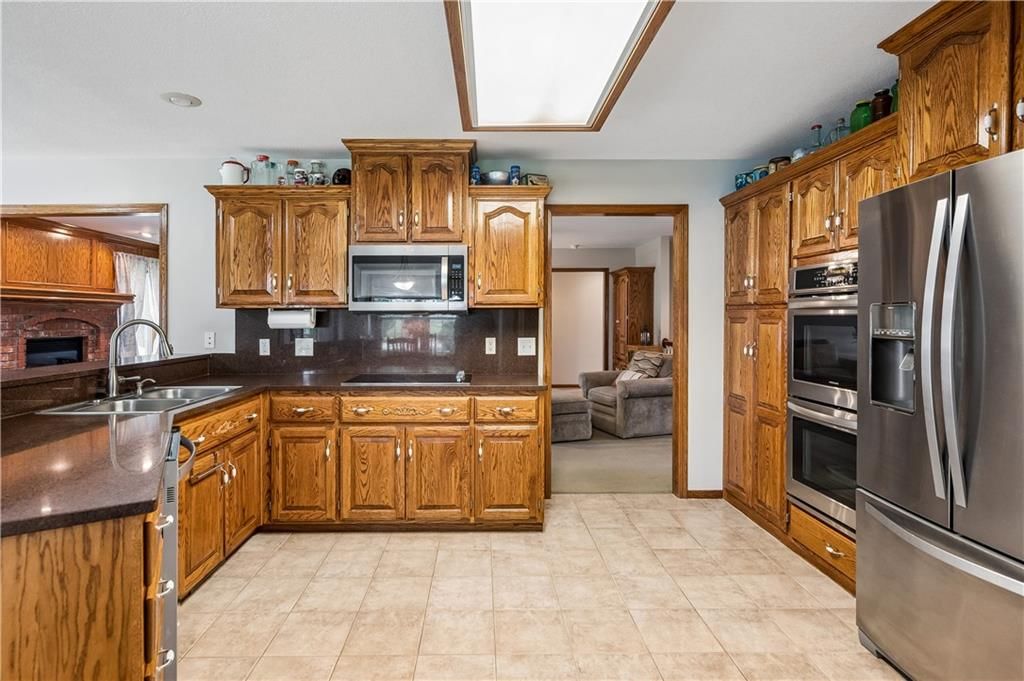 Kitchen island, double oven and breakfast nook at 1707 Lynn Road, Excelsior Springs, MO 64024