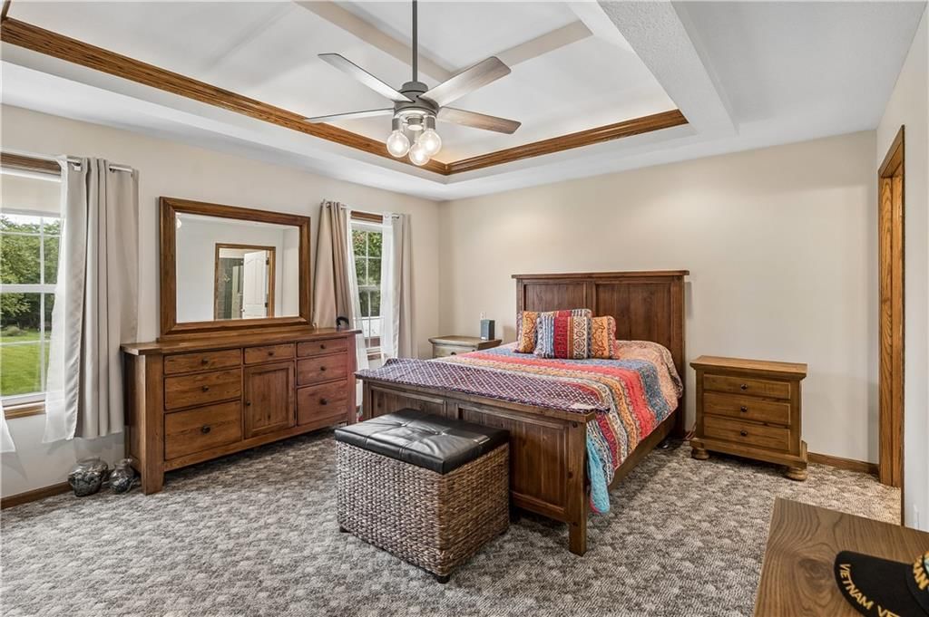 Main-floor primary bedroom and tray ceiling at 1707 Lynn Road, Excelsior Springs, MO 64024