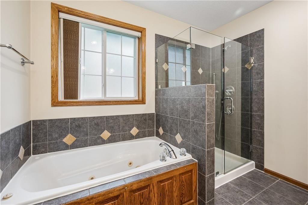 Walk-in shower and tiled shower at 1707 Lynn Road, Excelsior Springs, MO 64024