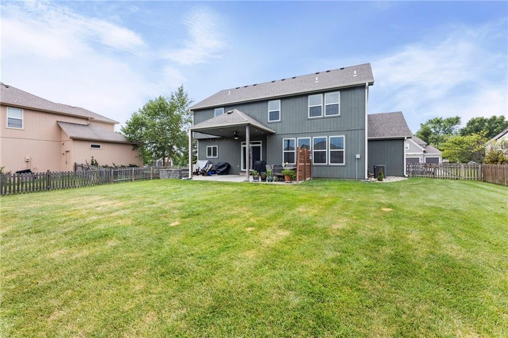 Fire pit and covered patio at 1800 Knoll Creek Lane, Raymore, MO 64083